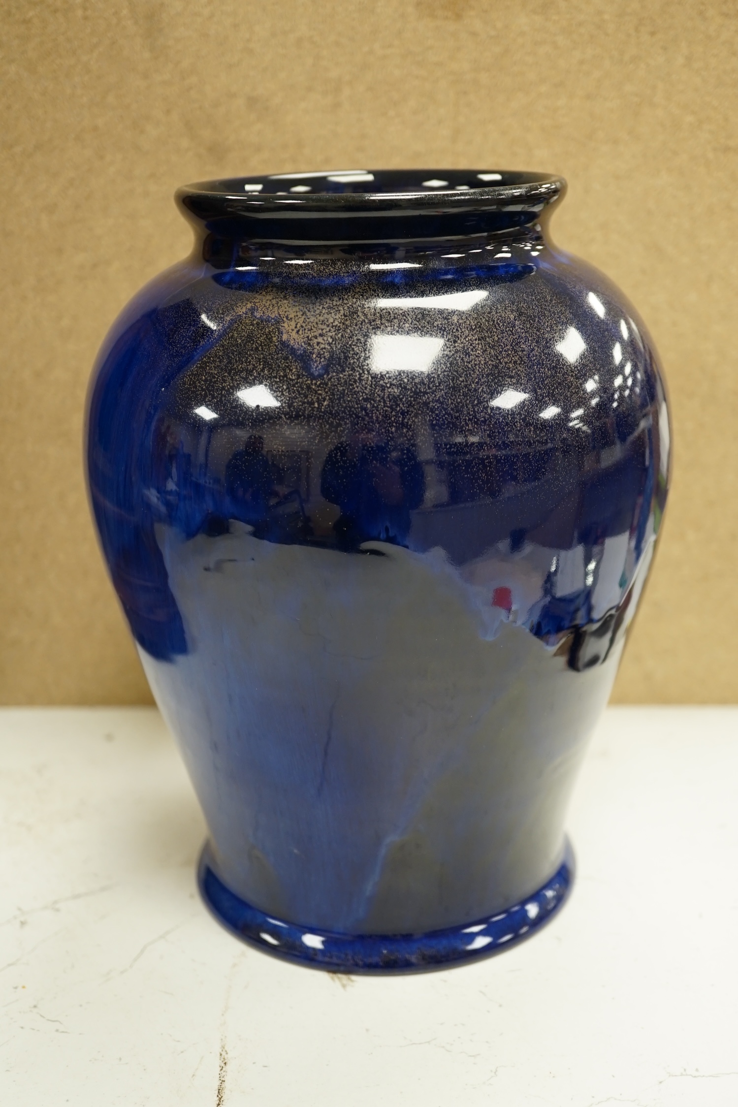 An experimental Doulton Lambeth blue glazed with gilt spray vase, 24cm. Condition - good